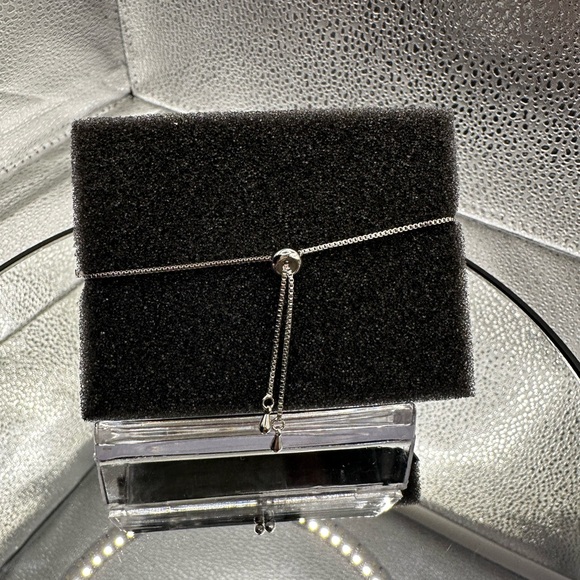 This bracelet is silver over brass with beautiful CZs and is adjustable. - Picture 6 of 8